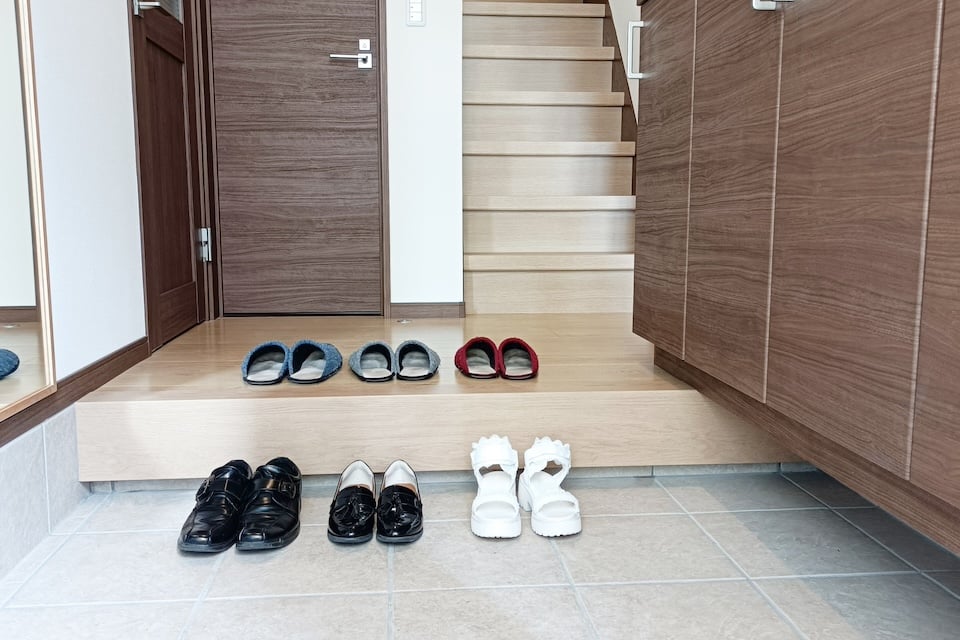 Shoes neatly arranged at a Japanese genkan entrance.