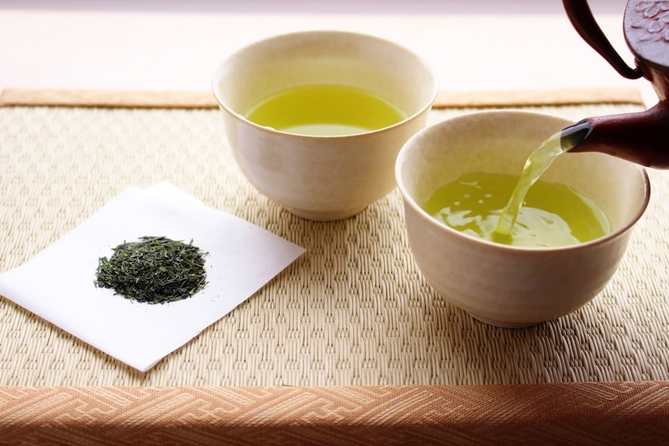 A cup of unsweetened green tea served in a traditional Japanese teacup.