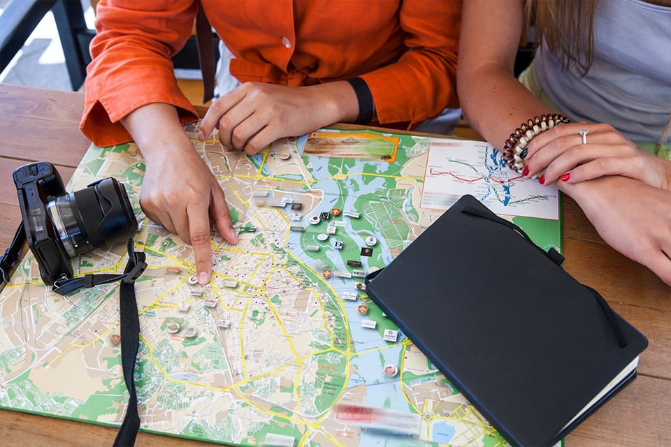 Travelers planning a Hakone day trip itinerary using a map