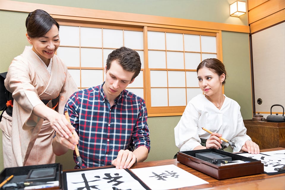 International corporate group enjoying cultural event planning services in Japan