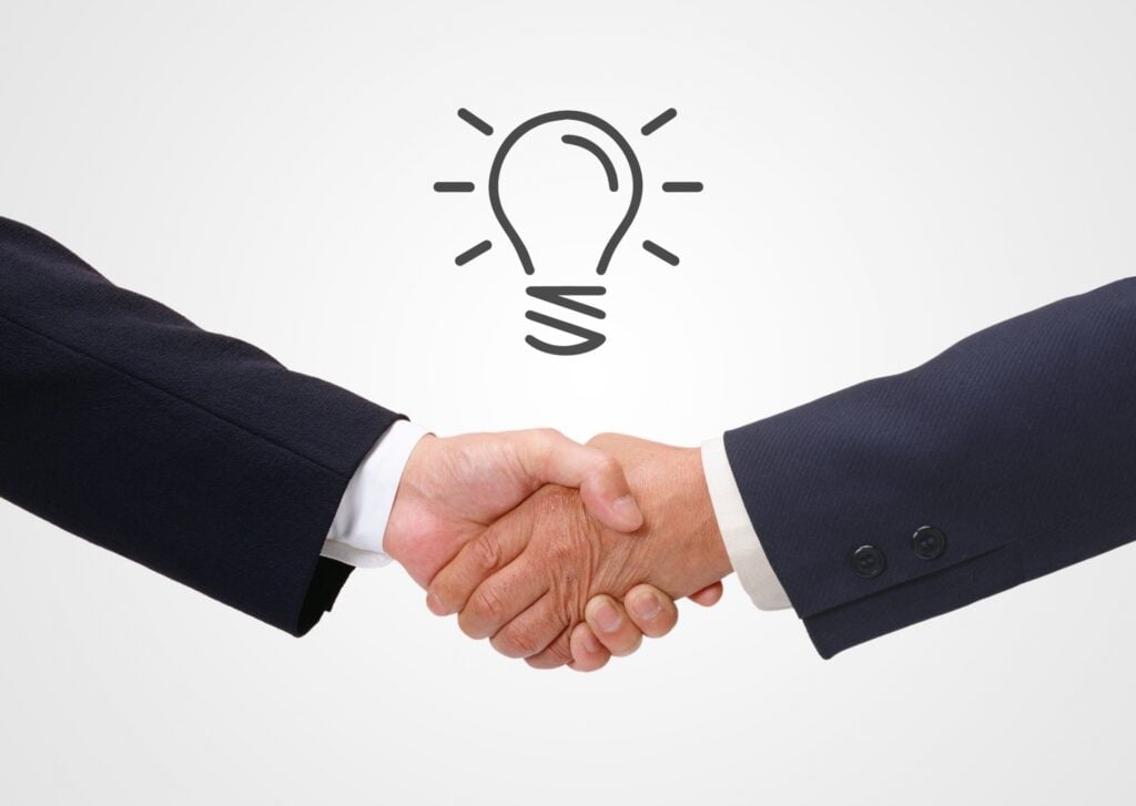Business professionals shaking hands after selecting a Japan DMC partner