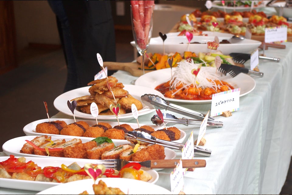 Corporate event venue with tables, audiovisual equipment, and catering setup in Tokyo