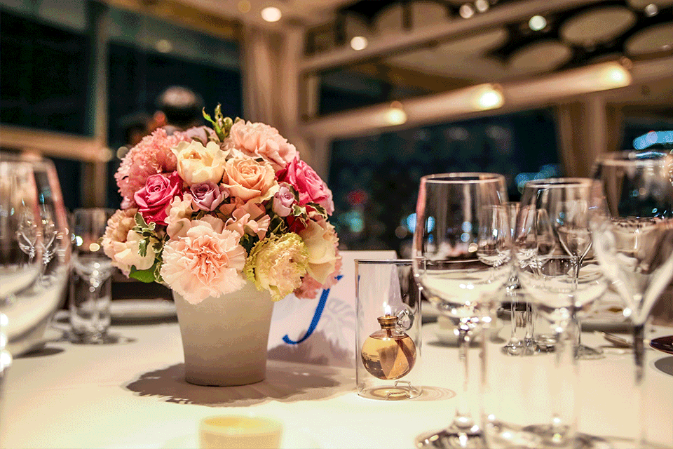 Ballroom layout with round tables, stage, and AV setup for a 300-guest gala dinner