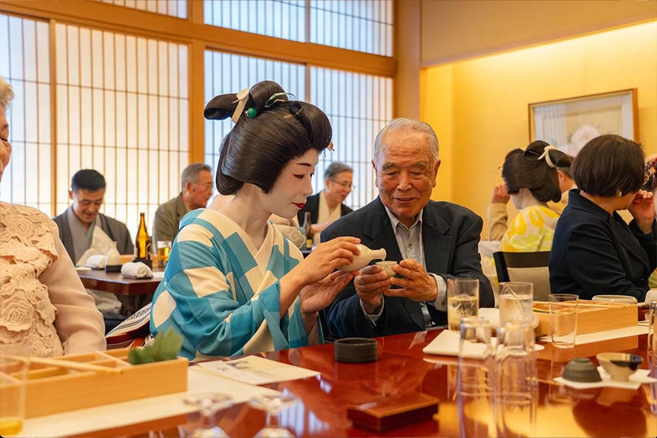 Traditional Japanese shamisen performance by a kimono-clad musician in a private tatami room