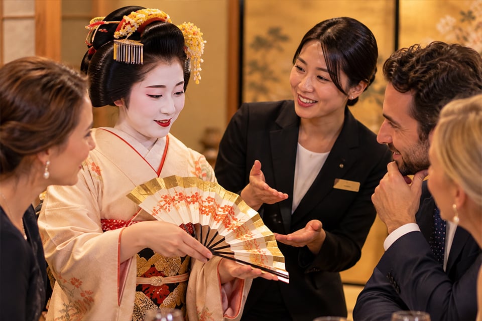 International business guests enjoying a private geisha dance performance and Japanese dinner in a traditional tatami room