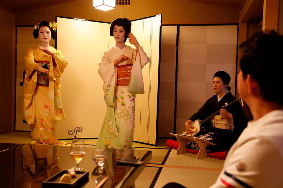 Geisha performing a traditional Japanese dance during a private dining experience at Tsukiji Jisaku in Tokyo