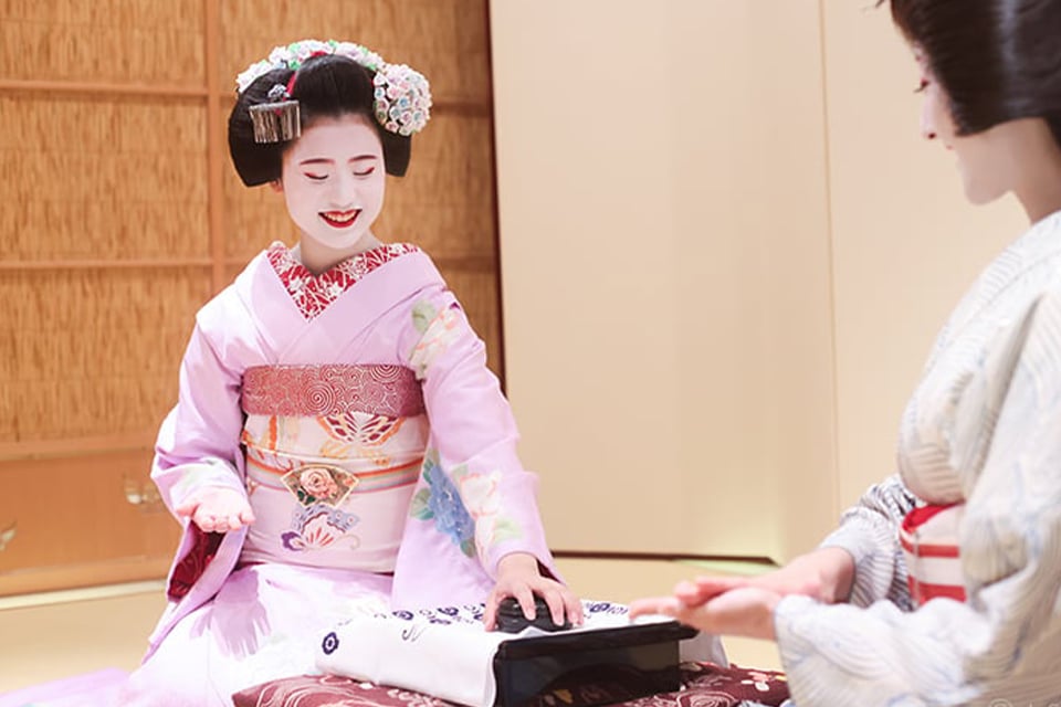 Geisha performing traditional Japanese dances accompanied by a shamisen musician at Gion Shizuka in Kyoto